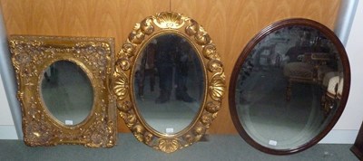 Lot 867 - A gilt wood oval wall mirror, the frame carved...