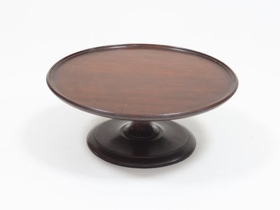 Lot 870 - A mahogany lazy susan with dish top on central...