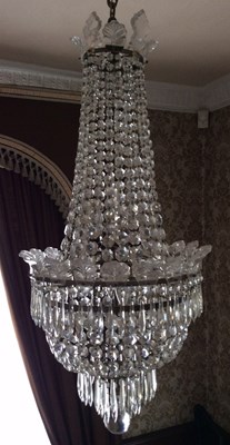 Lot 873 - A cut glass chandelier hung four tiers of...