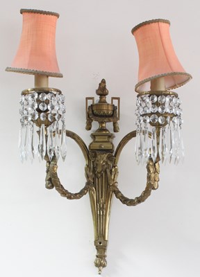 Lot 874 - A gilt brass two-branch wall light of Empire...