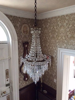 Lot 878 - A cut glass chandelier hung four tiers of...