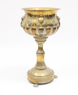 Lot 903 - An embossed brass jardini??re on a pedestal...