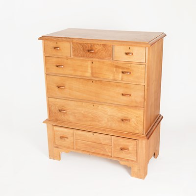 Lot 913 - A walnut chest on stand by Bert Uzzell, the...