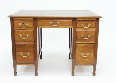 Lot 915 - A mahogany kneehole desk fitted a surround of...