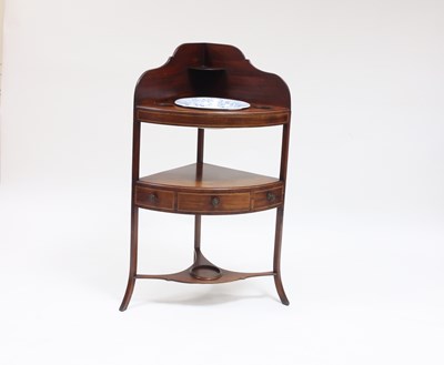 Lot 938 - A George III mahogany corner wash stand with...