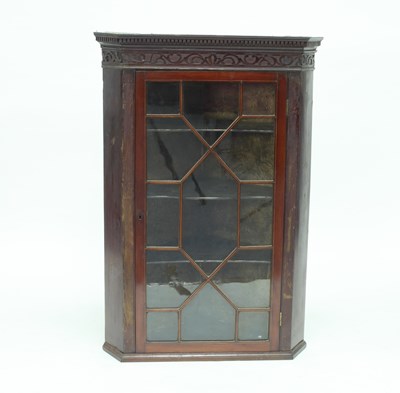 Lot 978 - A George III mahogany hanging corner cupboard...