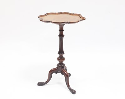 Lot 985 - A Victorian walnut tripod table with wavy pie...