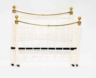 Lot 999 - A cast iron and brass bedstead with cream...