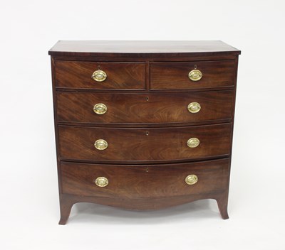 Lot 1004 - A Regency bowfront chest of drawers of two...