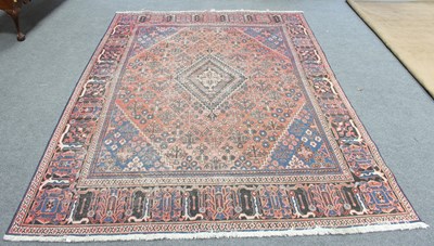 Lot 2 - An Afghan carpet with central indigo lozenge...