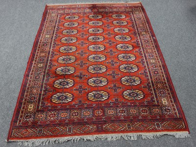 Lot 4 - An Eastern rug of Bokhara design, the red...