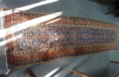 Lot 8 - A Feraghan runner, the geometric blue ground...