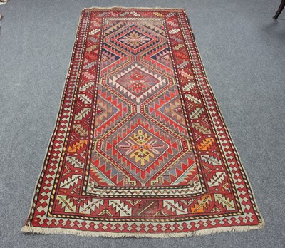 Lot 10 - A Kelim style rug, the central triple pole...