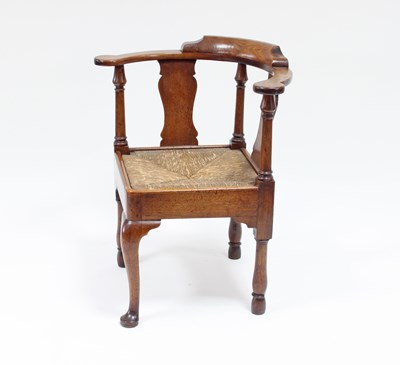 Lot 31 - A George II walnut corner chair with cabriole...