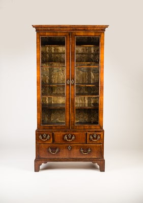 Lot 33 - A George II walnut two-door cabinet, the later...