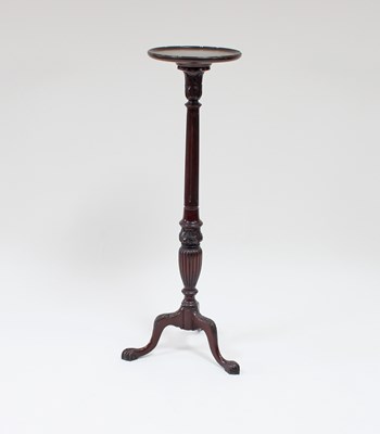 Lot 88 - A mahogany torchere with reeded baluster...