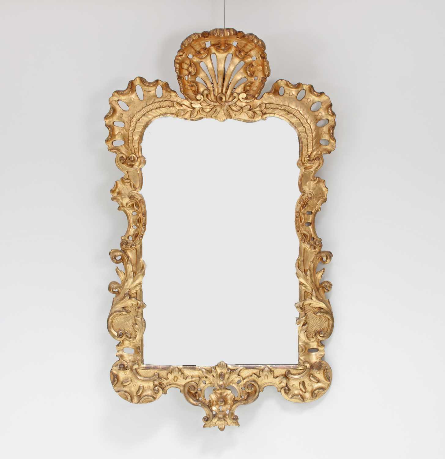 Lot 97 - A George II giltwood mirror, the frame with...