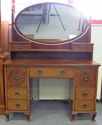 Lot 135 - A walnut kneehole dressing table, fitted a...