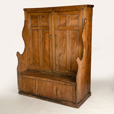 Lot 143 - An 18th Century elm bacon settle with two four-...