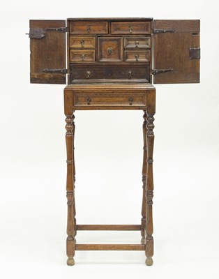 Lot 156 - A 17th Century oak spice cupboard, the panel...