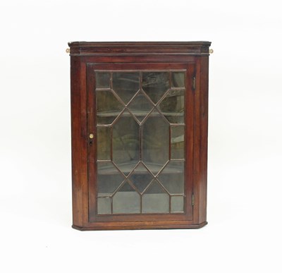 Lot 157 - A George III mahogany corner cupboard, the...