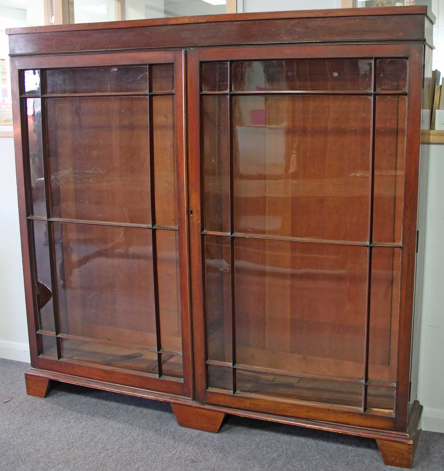 Lot 187 A mahogany bookcase enclosed by twin glazed
