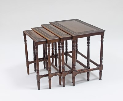 Lot 191 - A nest of four tables with carved borders to...