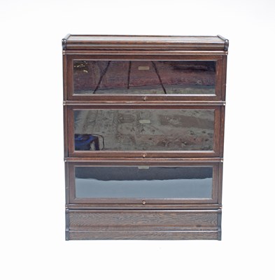 Lot 211 - An oak three-tier Globe Wernicke bookcase,...