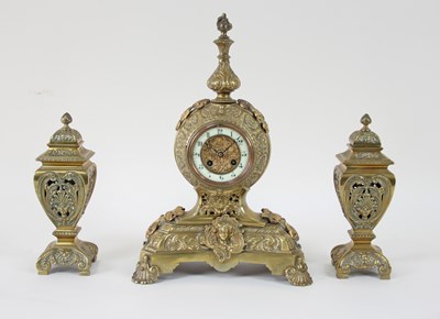 Lot 223 - A French brass mantel clock and urn garniture,...