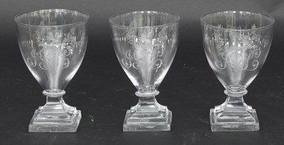 Lot 305 - A set of three glass rummers, each engraved...