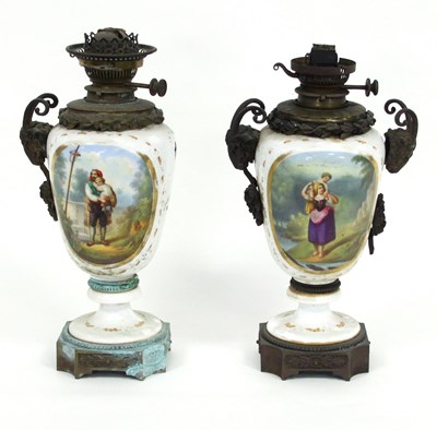 Lot 354 - A pair of French porcelain oil lamps with gilt...