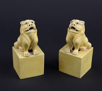 Lot 414 - A pair of Chinese yellow glazed lion dogs,...