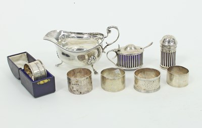 Lot 606 - Five silver napkin rings, one in a folding...