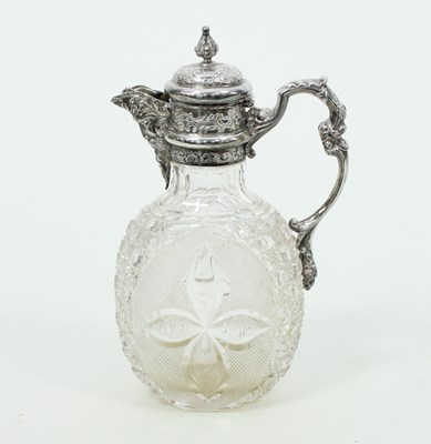 Lot 611 - An oval cut glass claret jug, William Comyns,...