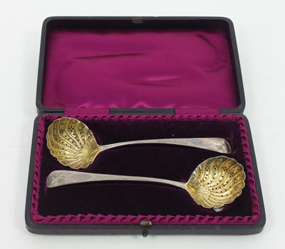 Lot 628A - A pair of George III bright cut sugar ladles,...