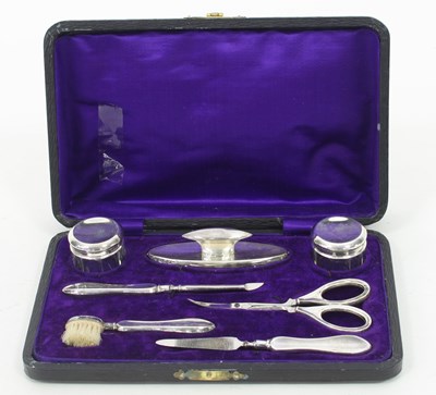 Lot 653 - A silver mounted manicure set, Birmingham 1918,...