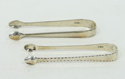 Lot 655 - A pair of George III silver bright cut sugar...