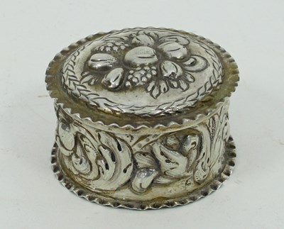 Lot 661 - A small circular silver coloured box, the lid...