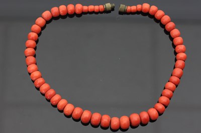 Lot 682 - A red coral bead necklace, of 51 beads strung...