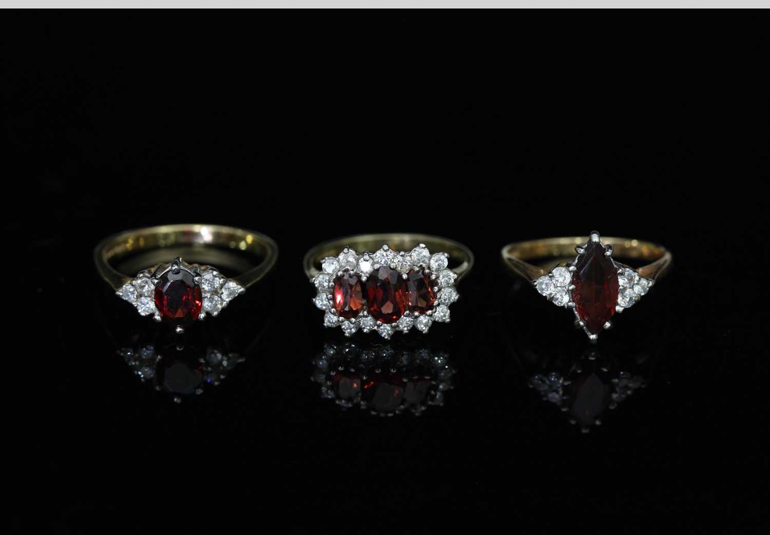 Lot 108 - A three-stone cluster dress ring, on a 9ct