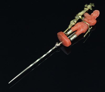 Lot 117 - A coral and gold mounted figural stick pin,...