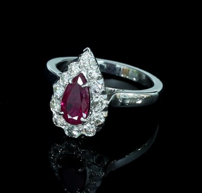 Lot 135 - A ruby and diamond cluster ring, the...