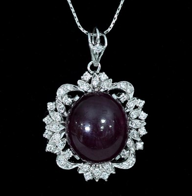 Lot 137 - A ruby and diamond pendant, the large central...