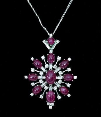 Lot 138 - A ruby and diamond pendant of starburst form,...