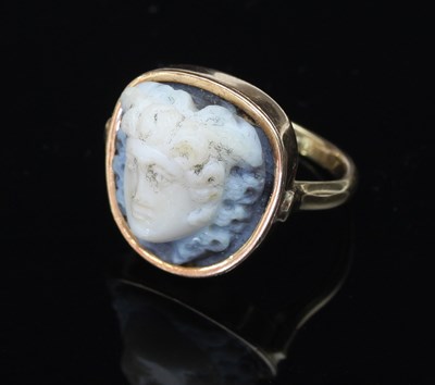 Lot 158 - A carved hardstone ring, the shaped plaque...