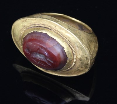 Lot 159 - An intaglio carved ring, the oval carnelian...