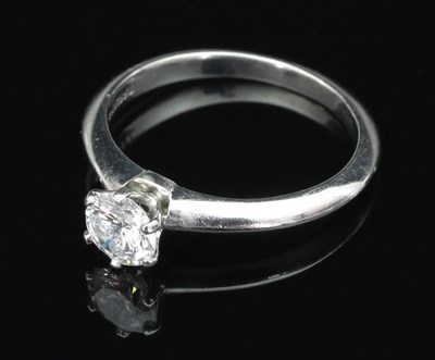 Lot 167 - A Tiffany & Co. diamond solitaire ring set in...