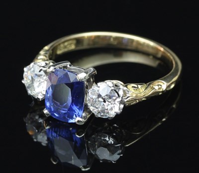 Lot 172 - A sapphire and diamond three-stone ring, the...