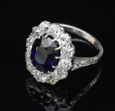 Lot 182 - A sapphire and diamond cluster ring, the...