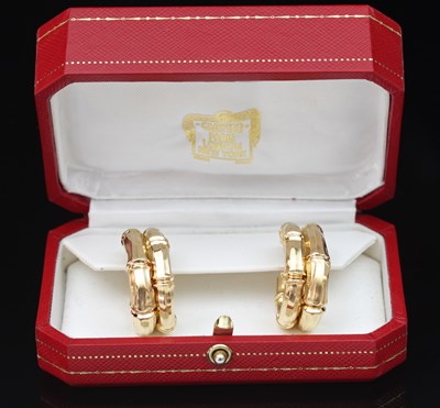 Lot 183 - A pair of Cartier gold 'bamboo' earrings, each...